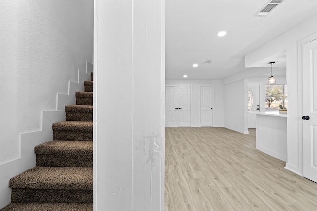 staircase featuring hardwood / wood-style flooring