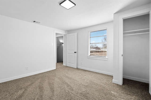 unfurnished bedroom featuring carpet flooring and a closet