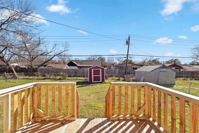 wooden terrace featuring a lawn