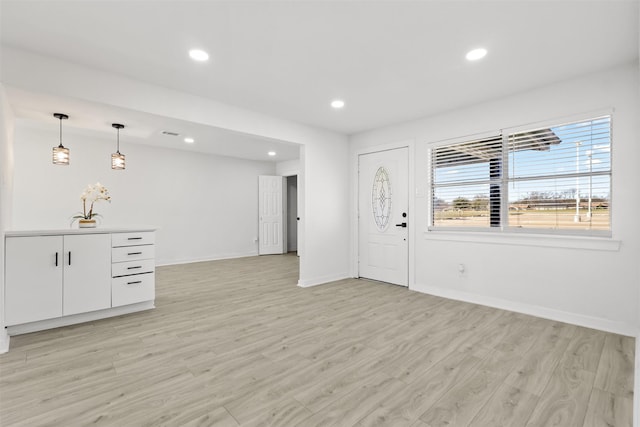 foyer entrance with light hardwood / wood-style floors