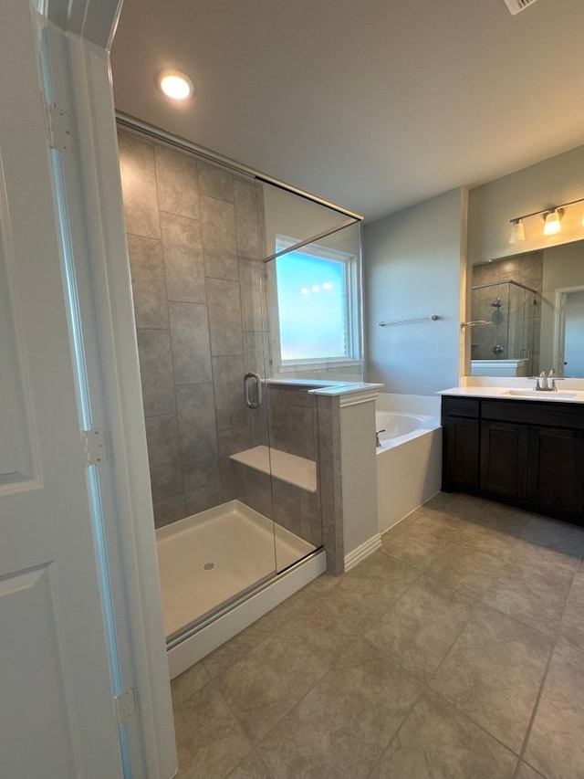 bathroom with a shower stall, vanity, and a bath