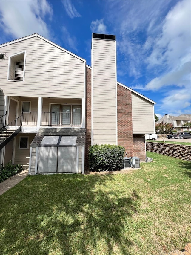 view of side of property with a yard