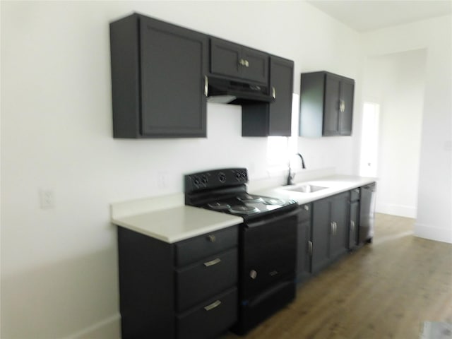 kitchen with black electric range oven, dark wood-type flooring, and sink