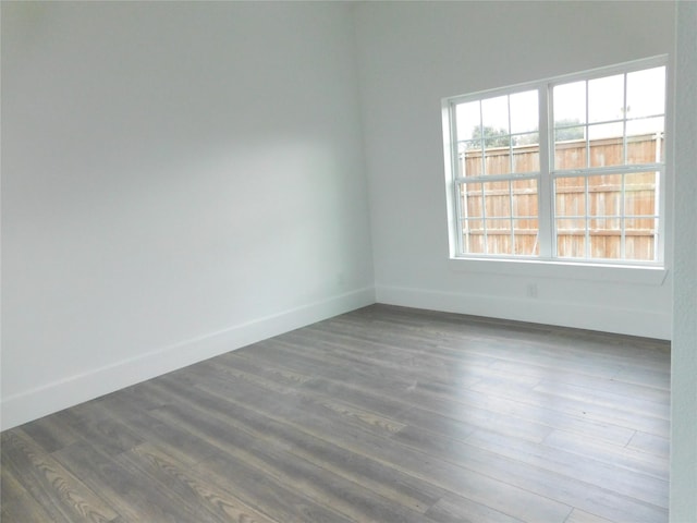 spare room with dark wood-type flooring