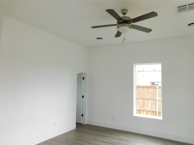 unfurnished room featuring dark hardwood / wood-style floors and ceiling fan