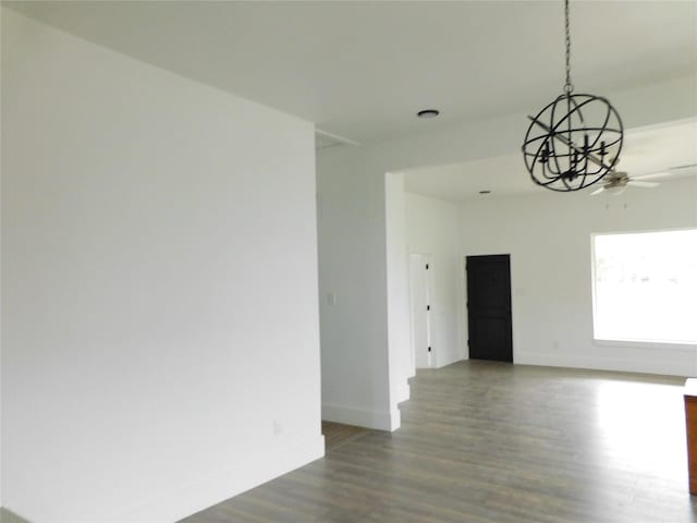 unfurnished room featuring ceiling fan with notable chandelier and wood-type flooring