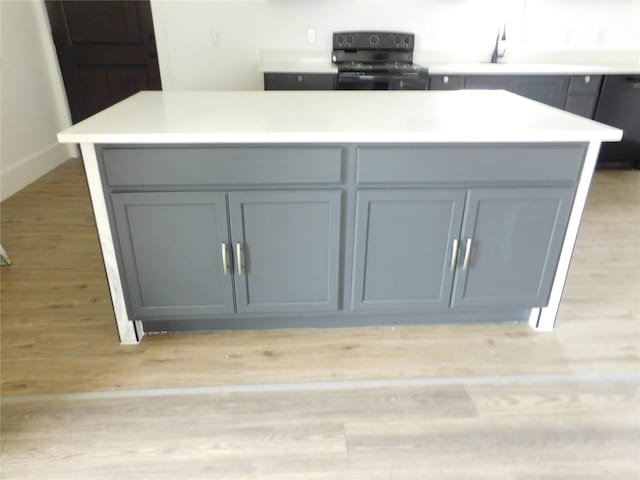 details with a center island, black range with electric stovetop, light hardwood / wood-style flooring, and gray cabinetry