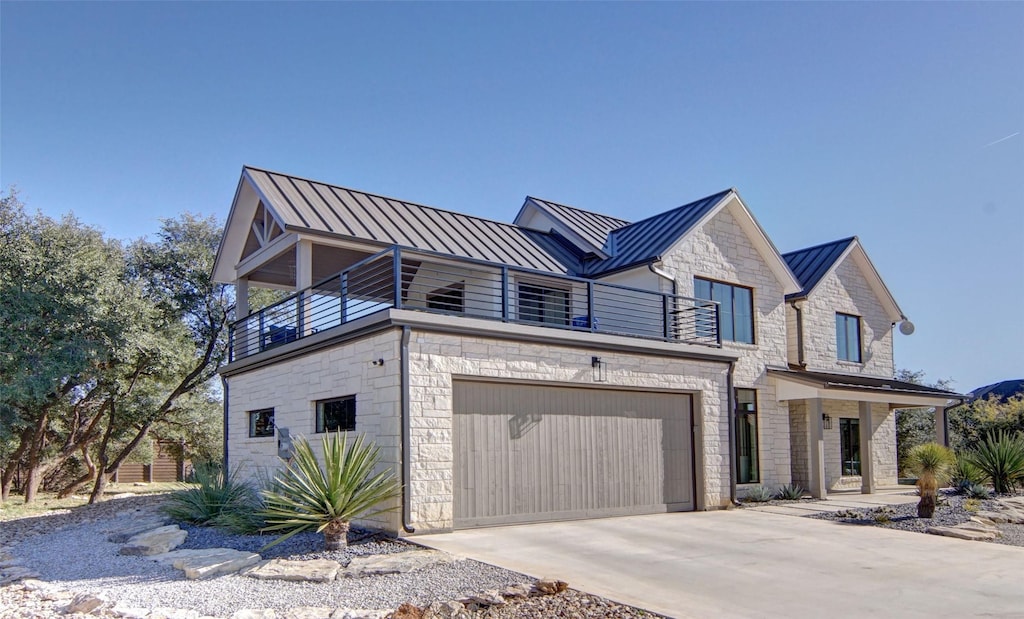 view of front of property with a garage and a balcony