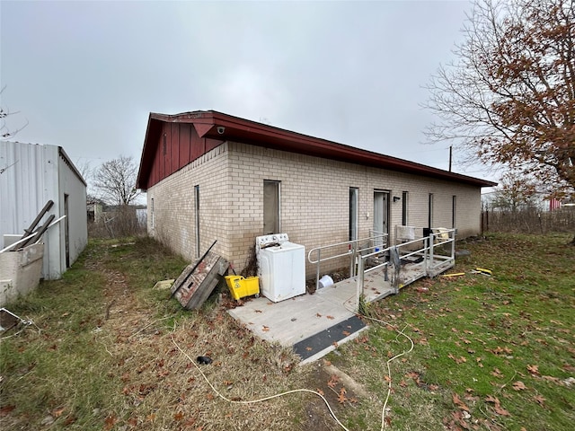 view of property exterior with washer / clothes dryer