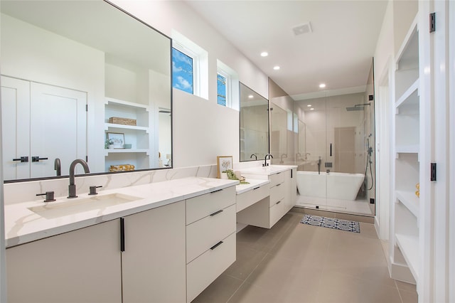 bathroom with shower with separate bathtub, vanity, and tile patterned floors