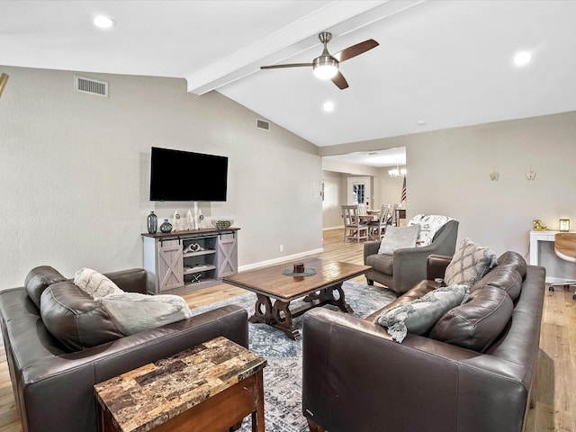 living room featuring hardwood / wood-style floors, lofted ceiling with beams, and ceiling fan