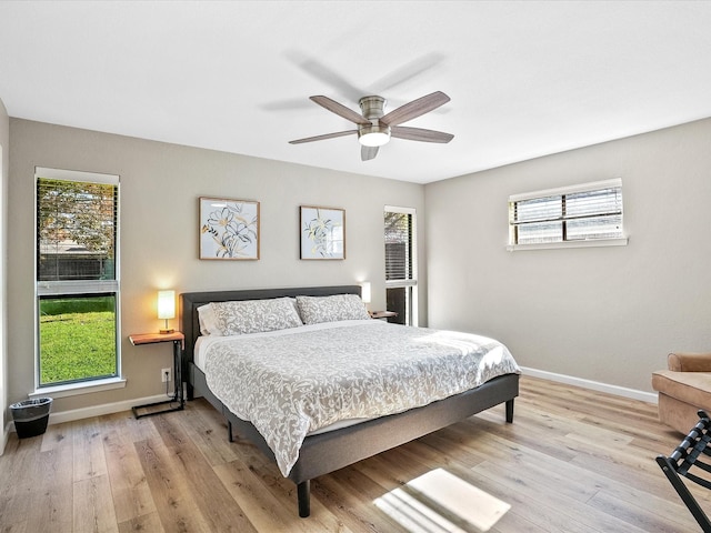 bedroom with light hardwood / wood-style flooring and ceiling fan