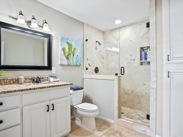 bathroom with tile patterned floors, vanity, toilet, and a shower with shower door