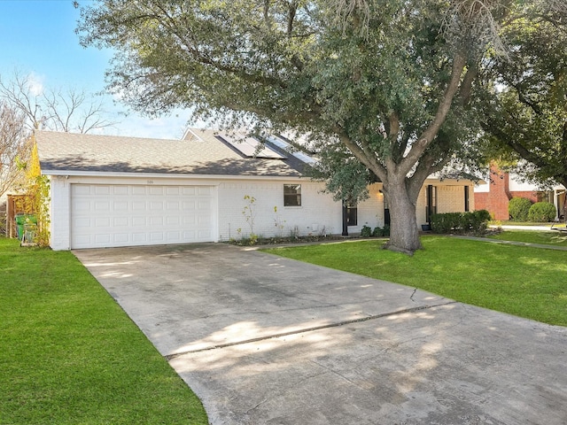 view of front of property with a garage and a front yard