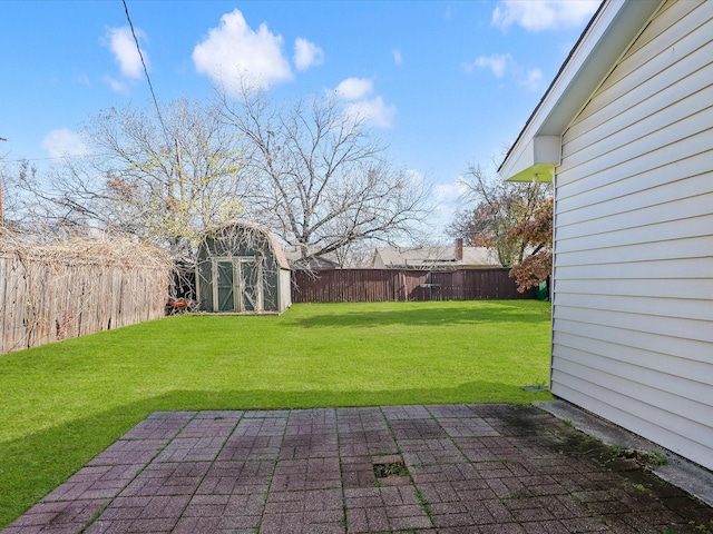 view of yard featuring a storage unit and a patio area