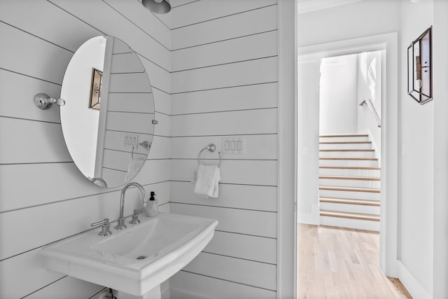 bathroom featuring hardwood / wood-style flooring and wood walls