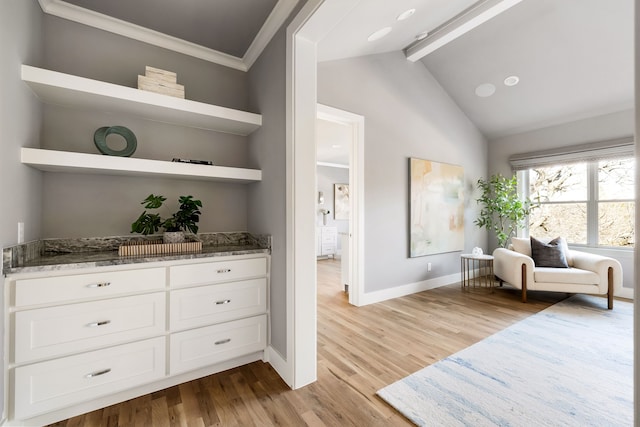 living area with beamed ceiling, high vaulted ceiling, and light hardwood / wood-style flooring