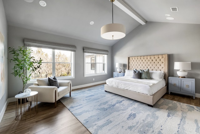 bedroom featuring dark hardwood / wood-style flooring and lofted ceiling with beams