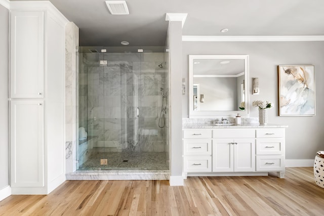 bathroom featuring vanity, an enclosed shower, and wood-type flooring