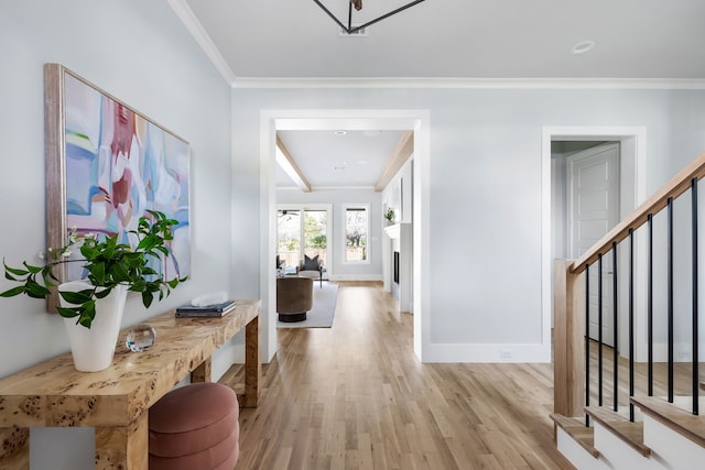 entryway featuring light wood-type flooring and ornamental molding