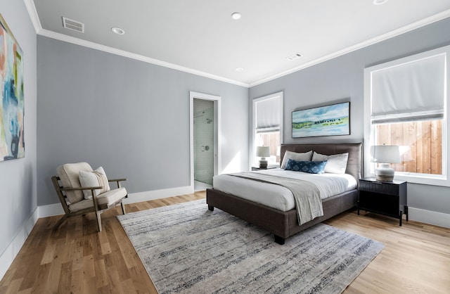 bedroom featuring light hardwood / wood-style flooring and crown molding