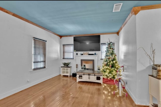 living room with light hardwood / wood-style floors and ornamental molding