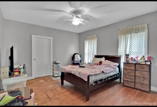 bedroom with wood-type flooring and ceiling fan