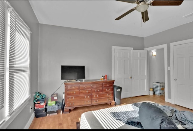 bedroom with ceiling fan and light hardwood / wood-style floors