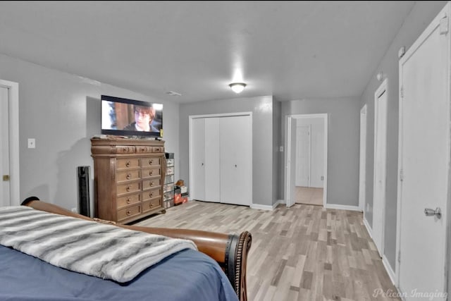 bedroom featuring light wood-type flooring and a closet