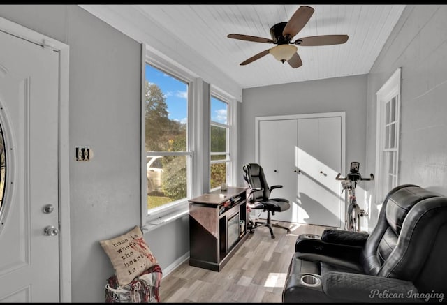 sunroom / solarium featuring ceiling fan