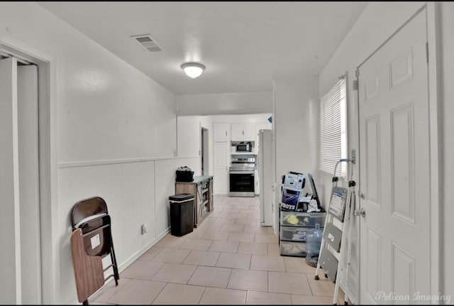 corridor with light tile patterned flooring