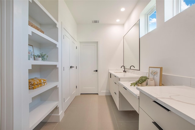 bathroom with tile patterned floors, built in features, and vanity