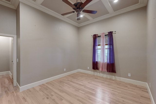 unfurnished room with coffered ceiling, crown molding, ceiling fan, light wood-type flooring, and beam ceiling