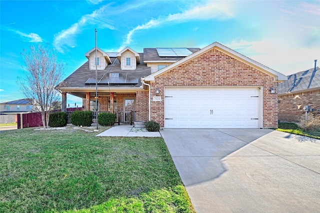 view of front facade with solar panels, a garage, and a front yard