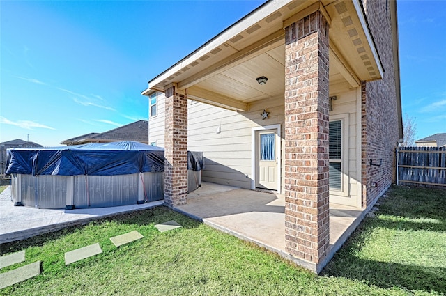 exterior space featuring a swimming pool, a patio area, and a lawn