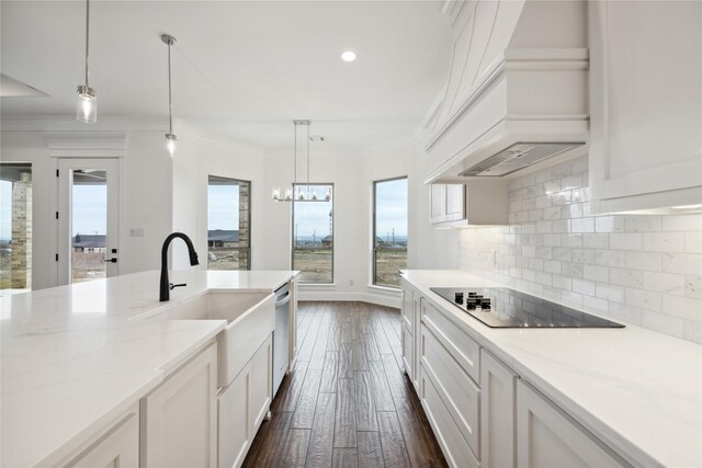 kitchen with black electric cooktop, pendant lighting, dark wood-type flooring, and custom exhaust hood