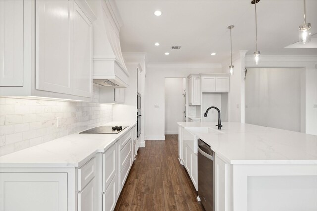 kitchen featuring black electric stovetop, decorative light fixtures, light stone countertops, and white cabinetry