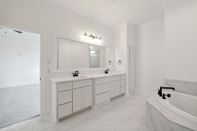 bathroom with vanity, ceiling fan, crown molding, and tiled tub