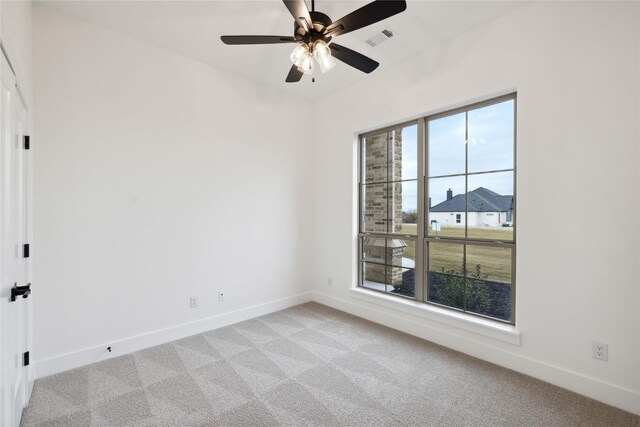 carpeted empty room featuring ceiling fan