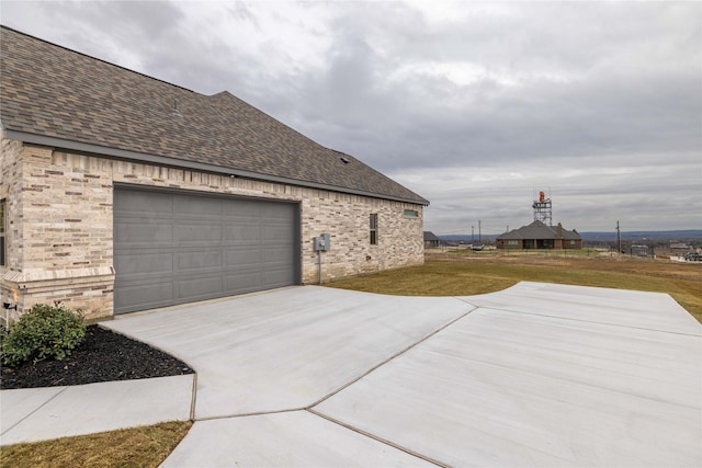 view of side of home with a lawn and a garage