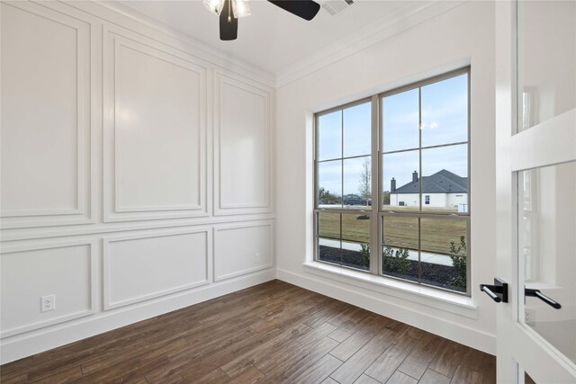 unfurnished room with ceiling fan, dark hardwood / wood-style flooring, and ornamental molding