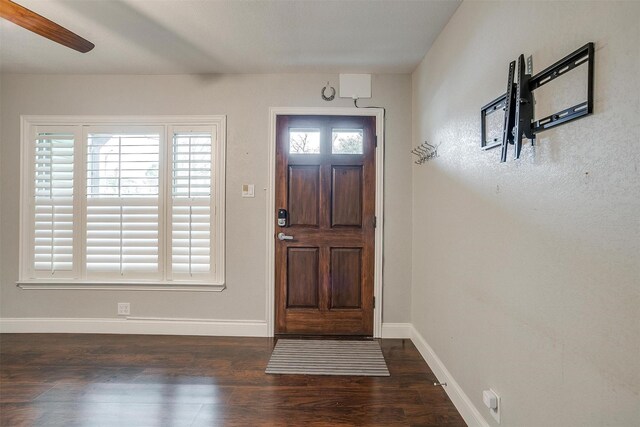 living room featuring ceiling fan, dark hardwood / wood-style flooring, and a textured ceiling