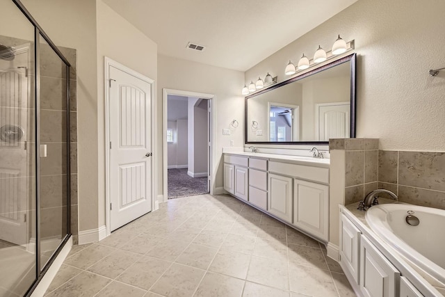 bathroom featuring vanity, tile patterned floors, and plus walk in shower