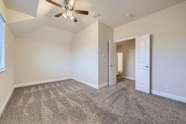 interior space featuring vaulted ceiling, ceiling fan, and dark carpet