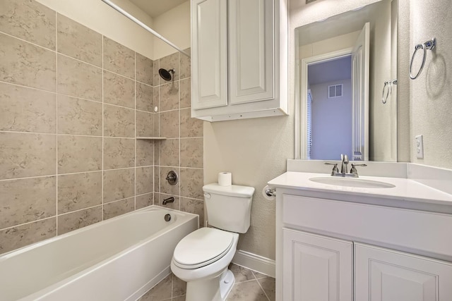 full bathroom with tile patterned flooring, vanity, tiled shower / bath combo, and toilet