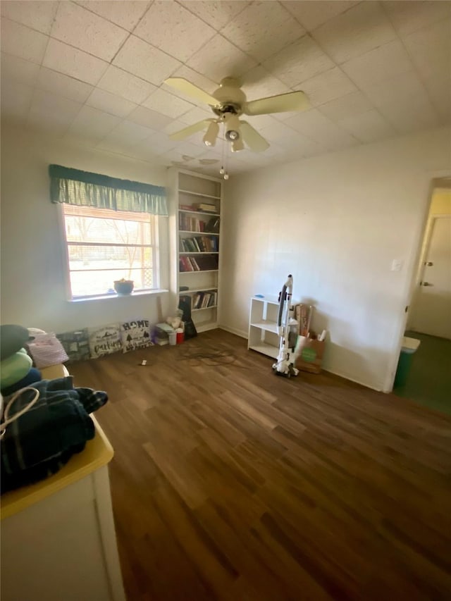 miscellaneous room featuring ceiling fan, built in features, and hardwood / wood-style floors