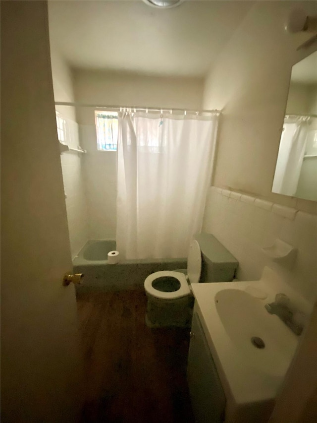 bathroom with toilet, tile walls, and vanity