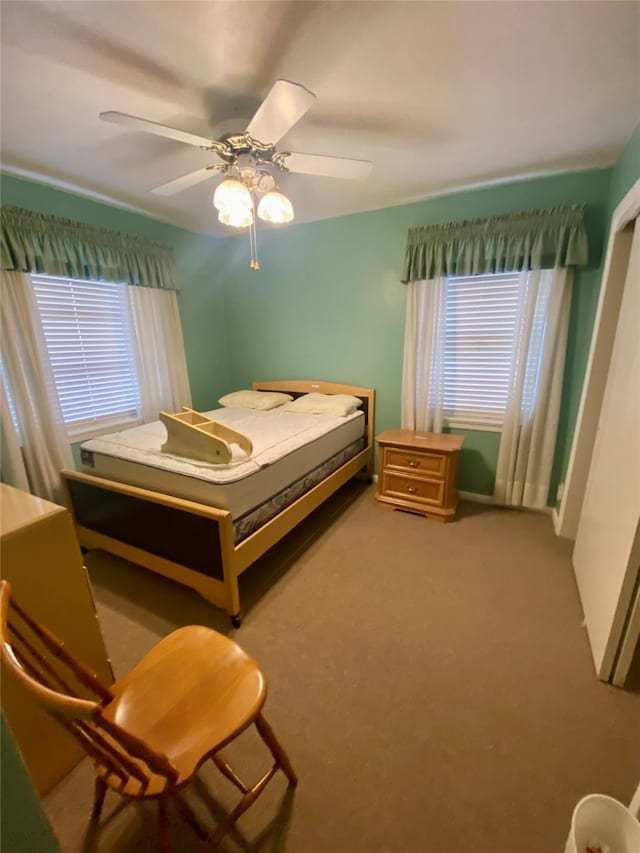 bedroom featuring ceiling fan and carpet