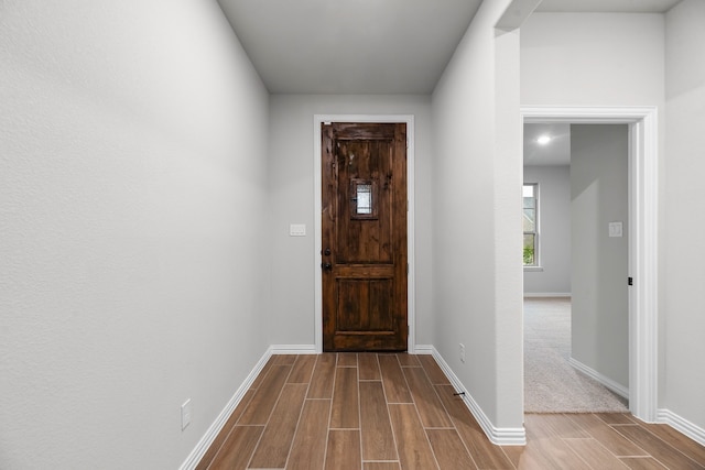 interior space with wood finish floors and baseboards