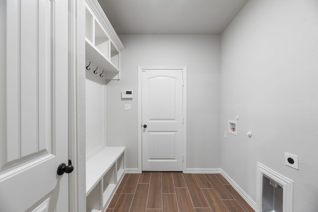 mudroom featuring dark wood-style flooring and baseboards